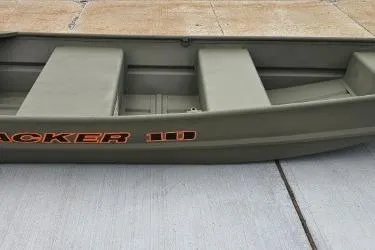 The Image of 2026 Tracker Grizzly 10 Jon boat, olive green, on concrete surface. - 0