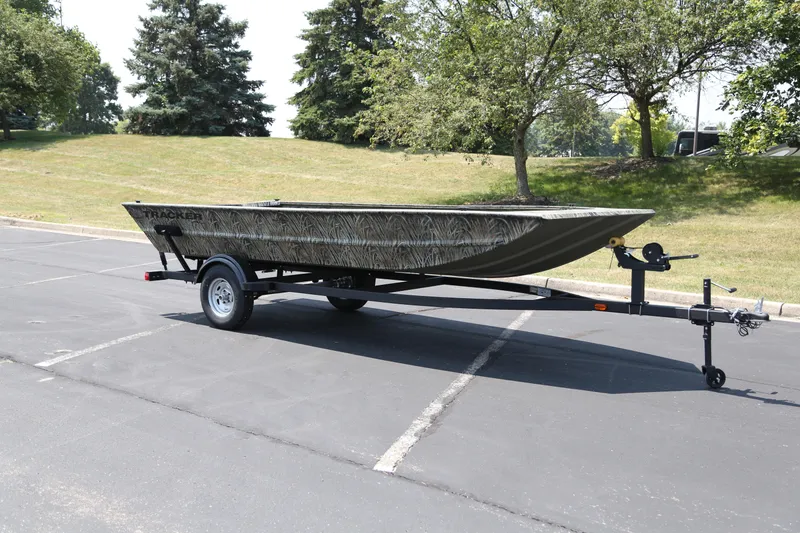 The Image of 2026 Tracker Grizzly 1754 Utility boat on trailer in parking lot. - 0
