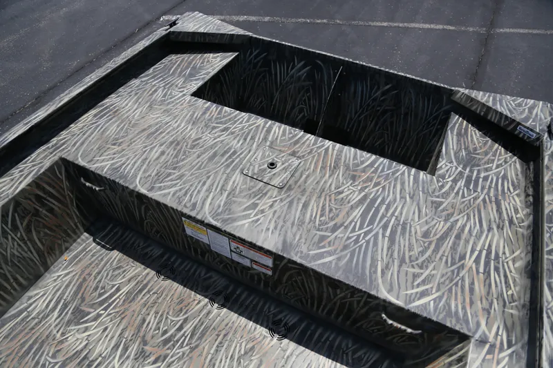Slide: The Image of 2026 Tracker Grizzly 1754 Utility boat interior with camouflage pattern and storage compartment. - 4
