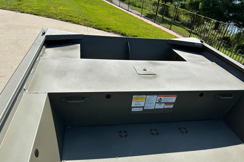 Slide: The Image of 2026 Tracker Grizzly 1754 Utility boat interior with storage compartments and safety labels. - 4