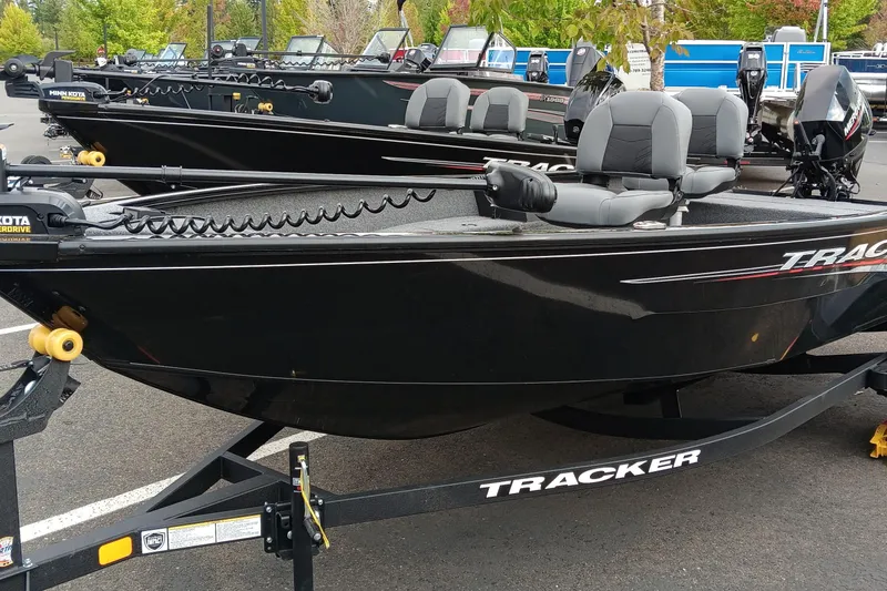 The Image of 2025 Tracker Super Guide V-16 T fishing boats displayed in a parking lot. - 0