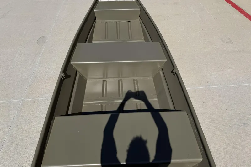 Slide: The Image of 2026 Tracker Grizzly 12 Jon boat interior with shadow on a concrete surface. - 3