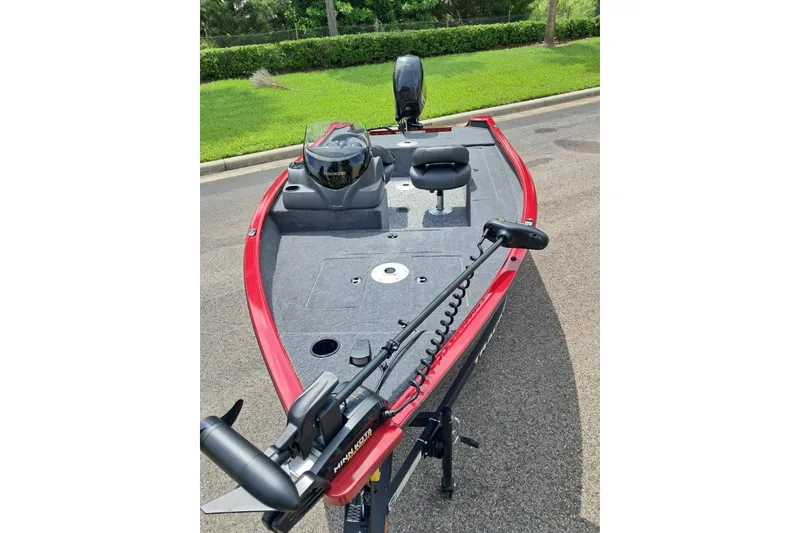 Slide: The Image of 2026 Tracker Super Guide V-16 SC fishing boat with red trim and trolling motor. - 2