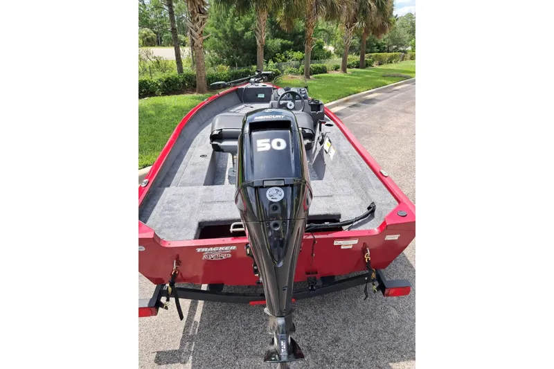 Slide: The Image of 2026 Tracker Super Guide V-16 SC boat with Mercury 50 engine, parked on a road. - 6