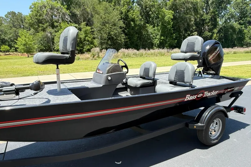 Slide: The Image of 2026 Tracker Bass Tracker Classic XL boat on trailer, parked outdoors. - 2