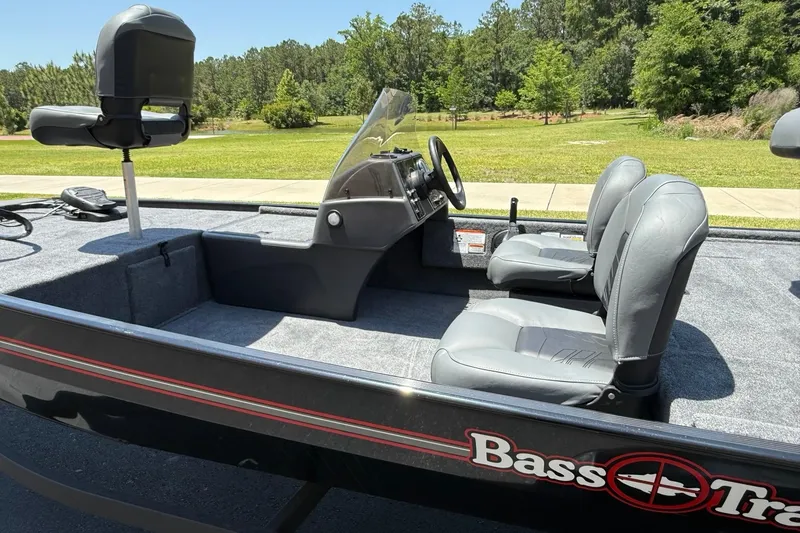 Slide: The Image of 2026 Tracker Bass Tracker Classic XL boat interior with gray seats and steering console. - 3