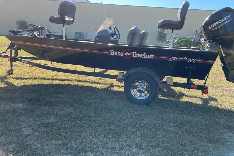 Slide: The Image of 2026 Tracker Bass Tracker Classic XL boat on trailer, parked on grass. - 60