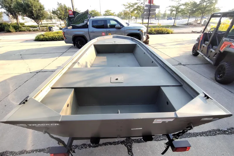 Slide: The Image of 2026 Tracker Grizzly 1648 Utility boat on trailer in parking lot. - 2