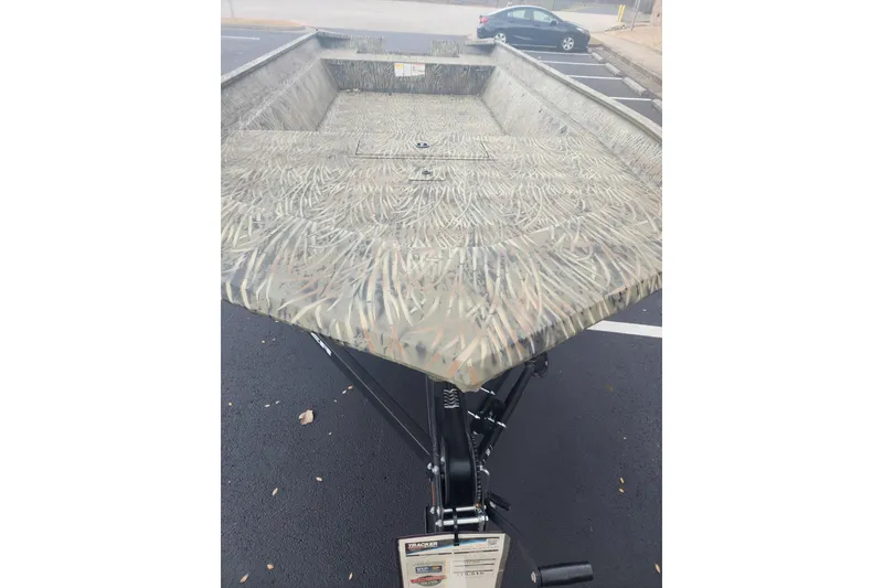 Slide: The Image of 2026 Tracker Grizzly 2072 Utility boat with camouflage pattern in a parking lot. - 20