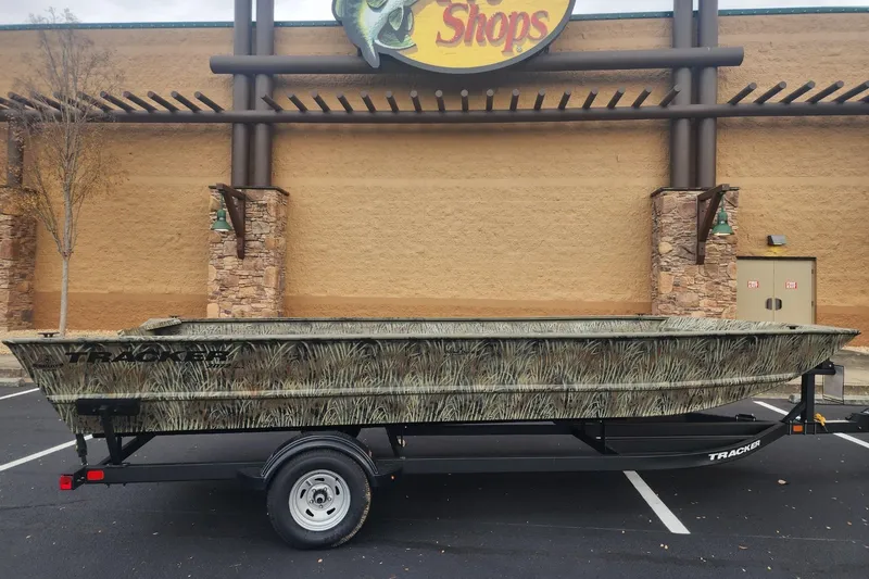 Slide: The Image of 2026 Tracker Grizzly 2072 Utility boat with camouflage design on a trailer. - 21
