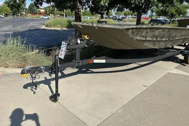 Slide: The Image of 2026 Tracker Grizzly 1754 Utility boat on trailer in parking lot. - 2