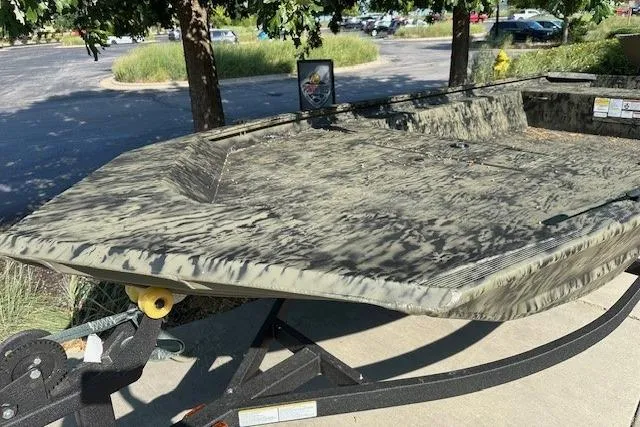 Slide: The Image of 2026 Tracker Grizzly 1754 Utility boat with camouflage design on a trailer. - 3