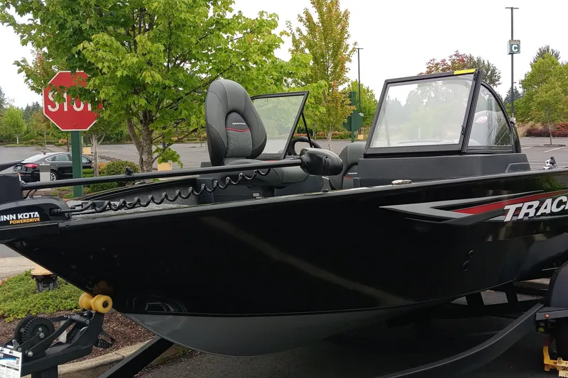 The Image of 2026 Tracker Pro Guide V-175 WT boat parked near trees and stop sign. - 0