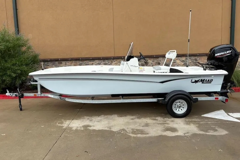 Slide: The Image of 2026 Mako Pro Skiff 17 CC boat on trailer, side view, outdoors. - 0