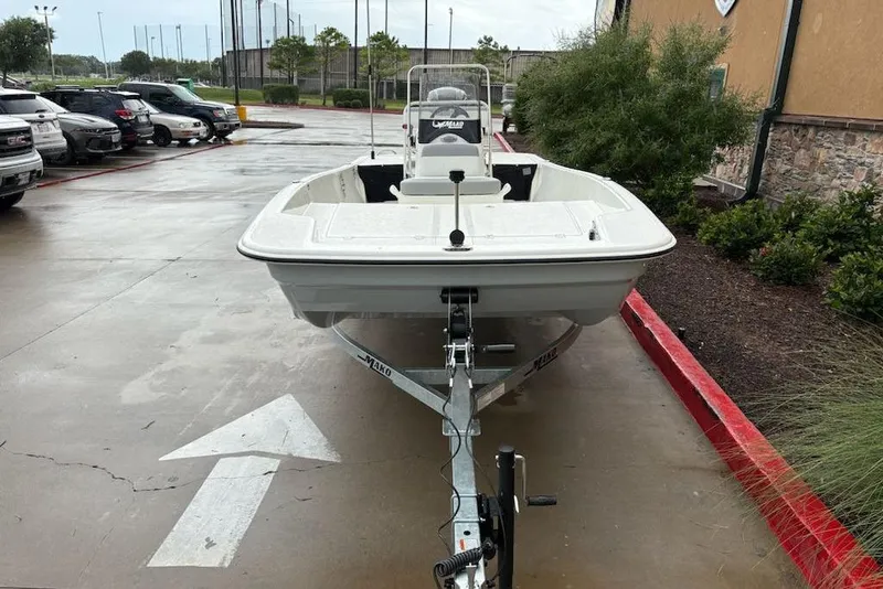 Slide: The Image of 2026 Mako Pro Skiff 17 CC boat on trailer in parking lot. - 1