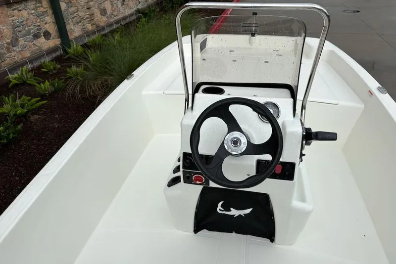 Slide: The Image of 2026 Mako Pro Skiff 17 CC boat console with steering wheel and controls. - 5