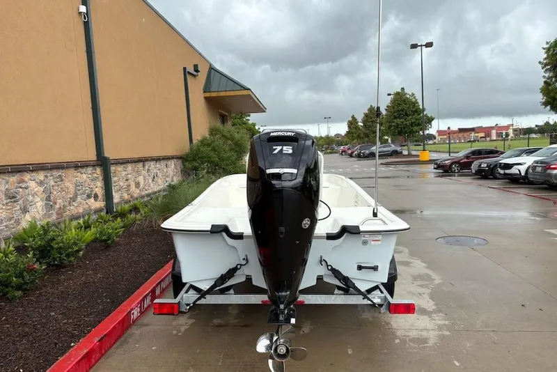 Slide: The Image of 2026 Mako Pro Skiff 17 CC with Mercury 75 engine in parking lot. - 6