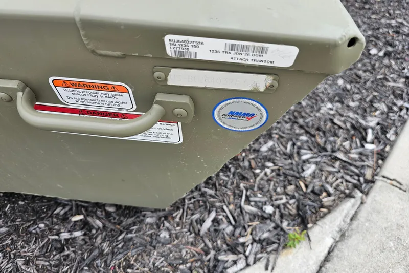 Slide: The Image of Close-up of a 2026 Tracker Grizzly 12 Jon boat transom with warning labels. - 6