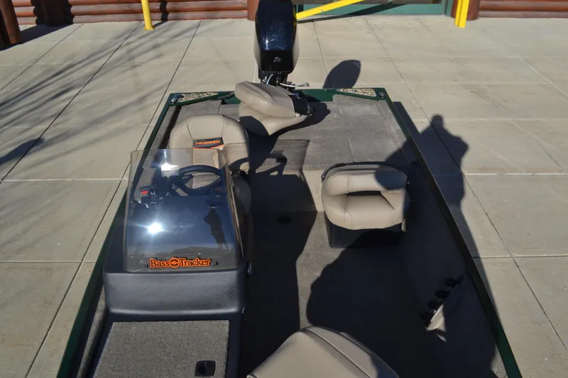 Slide: The Image of 2026 Tracker Bass Tracker Classic Limited boat interior with seating and steering console. - 6