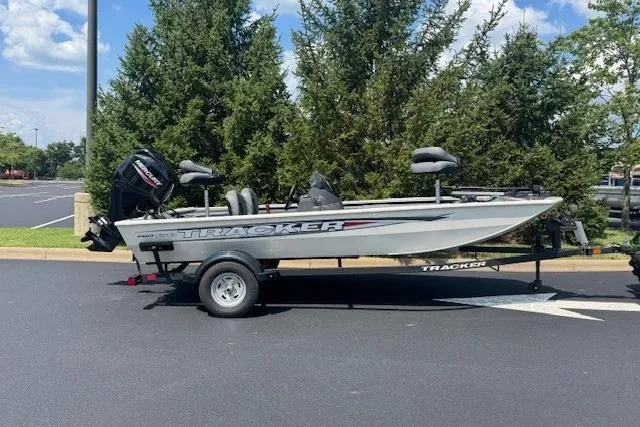 The Image of 2026 Tracker Pro 170 boat on trailer, parked outdoors, surrounded by trees. - 0