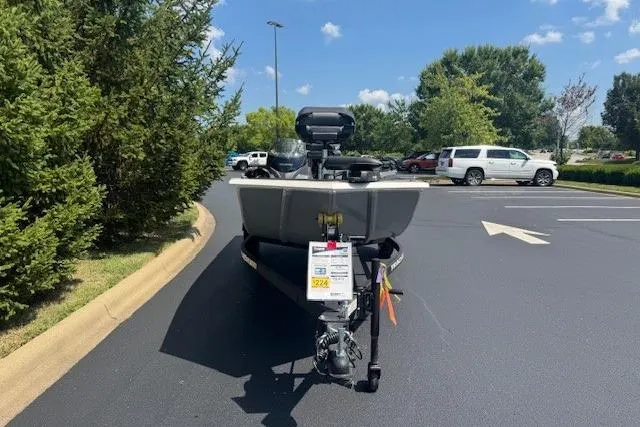 Slide: The Image of 2026 Tracker Pro 170 boat on trailer in parking lot, surrounded by trees and vehicles. - 2