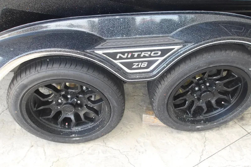 Slide: The Image of Black Nitro Z18 Pro 2026 wheels with stylish rims on concrete surface. - 6
