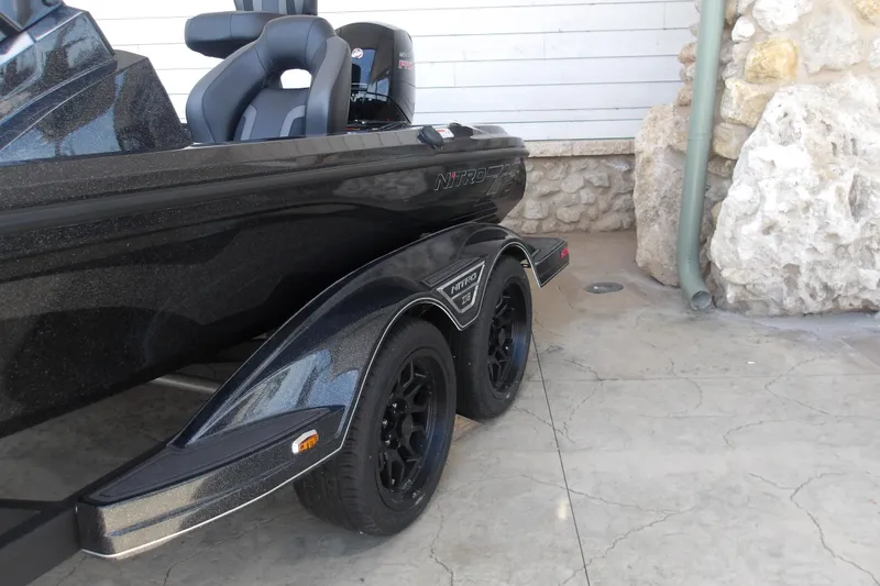 Slide: The Image of 2026 Nitro Z18 Pro boat with sleek black design and dual axle trailer. - 5
