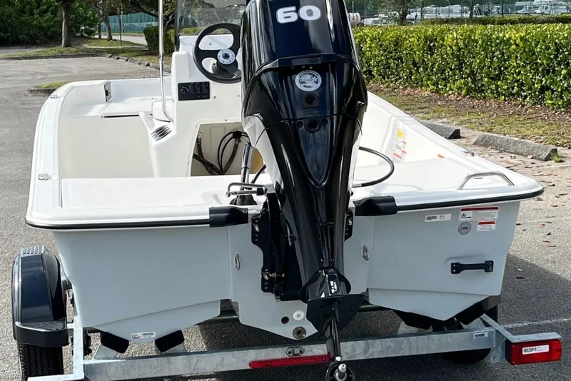 Slide: The Image of 2026 Mako Pro Skiff 15 CC boat on trailer, featuring a 60 HP outboard motor. - 3
