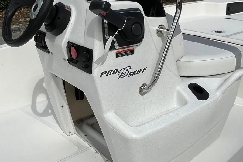 Slide: The Image of 2026 Mako Pro Skiff 15 CC boat console with steering wheel and controls. - 4