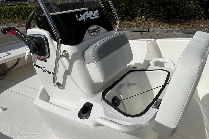 Slide: The Image of 2026 Mako Pro Skiff 15 CC boat interior with open storage compartment. - 6