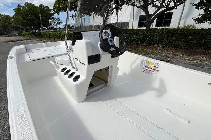 Slide: The Image of 2026 Mako Pro Skiff 15 CC boat interior with steering console and seating. - 7