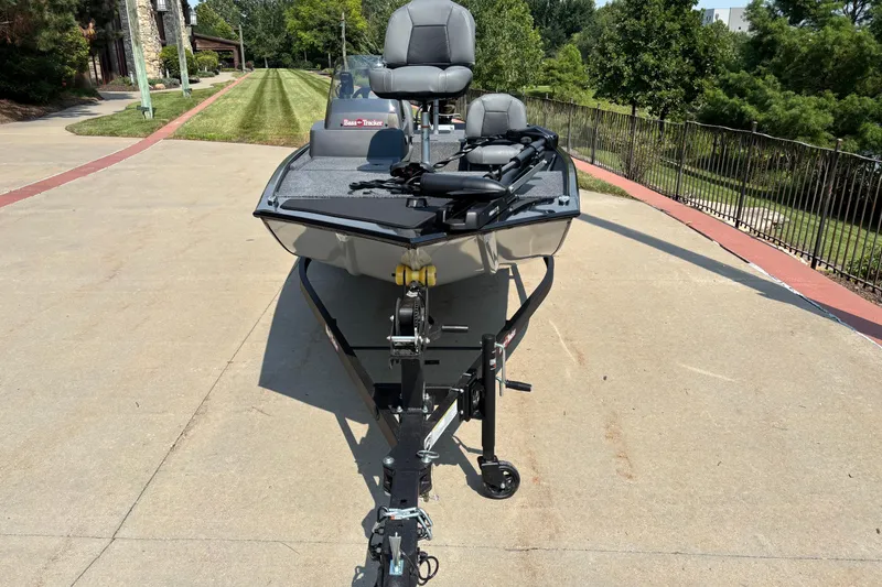 Slide: The Image of 2026 Tracker Bass Tracker Classic XL boat on trailer, parked on driveway. - 2