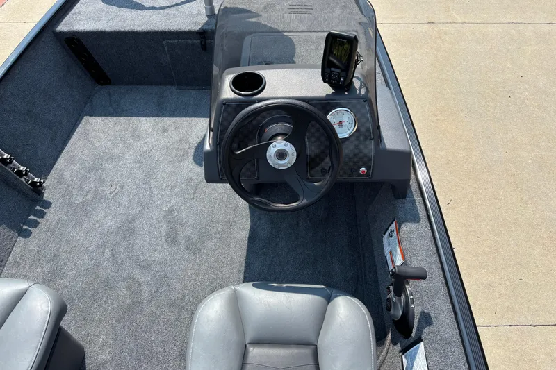 Slide: The Image of 2026 Tracker Bass Tracker Classic XL boat interior with steering wheel and dashboard controls. - 5