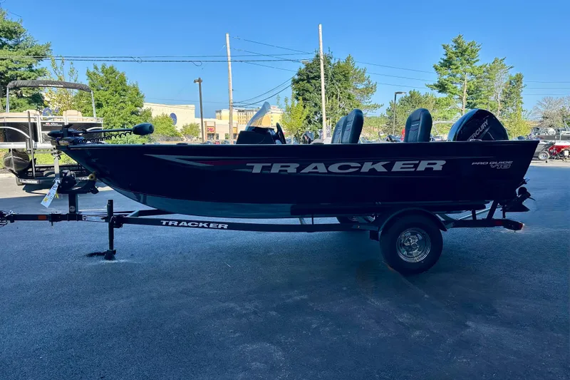 Slide: The Image of 2026 Tracker Pro Guide V-16 SC boat on trailer, parked outdoors. - 2
