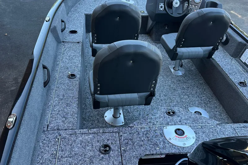 Slide: The Image of 2026 Tracker Pro Guide V-16 SC boat interior with seating and steering console. - 3