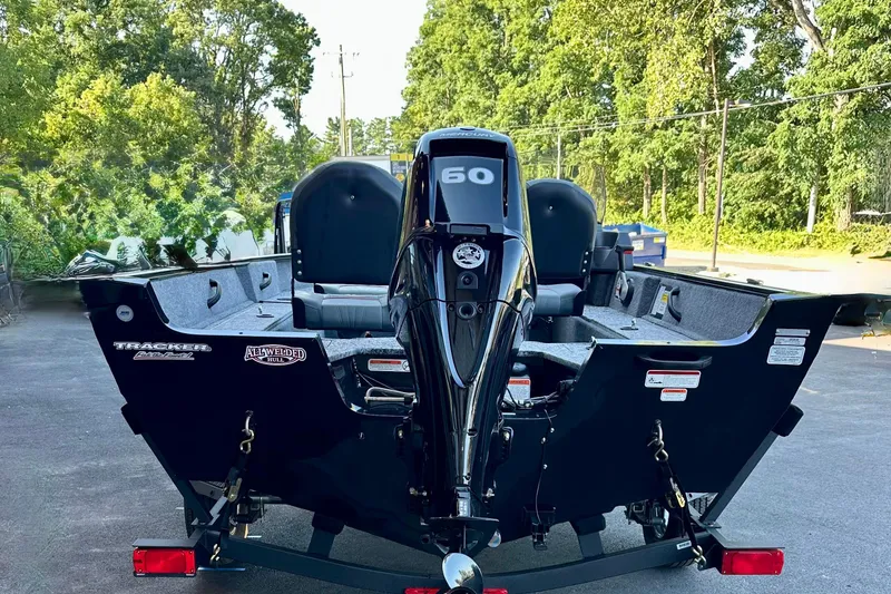 Slide: The Image of 2026 Tracker Pro Guide V-16 SC boat with 60 HP engine, parked outdoors. - 4