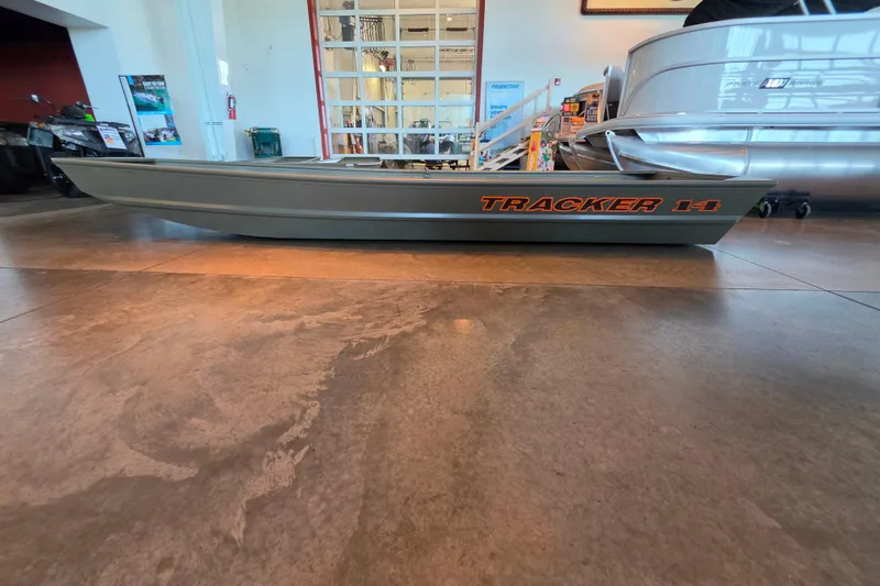 The Image of 2026 Tracker Grizzly 14 Jon boat displayed indoors on polished floor. - 0
