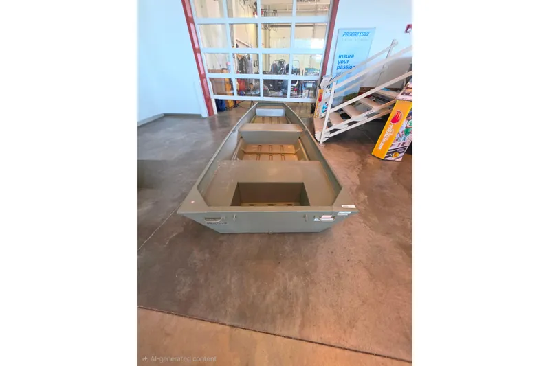 Slide: The Image of 2026 Tracker Grizzly 14 Jon boat displayed indoors on concrete floor. - 60