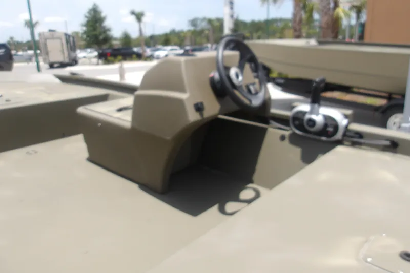 Slide: The Image of 2026 Tracker Grizzly 1648 SC boat interior with steering console and controls. - 5