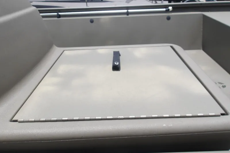 Slide: The Image of 2026 Tracker Grizzly 1648 SC boat storage compartment with secure latch. - 11