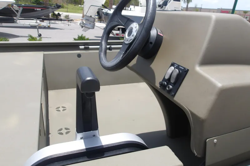 Slide: The Image of 2026 Tracker Grizzly 1648 SC boat console with steering wheel and controls. - 9
