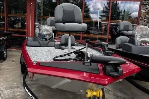 Slide: The Image of 2026 Tracker Pro 170 boat with red exterior and gray seating, displayed outdoors. - 2