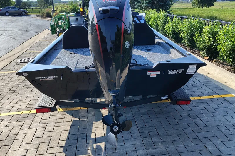 Slide: The Image of 2026 Tracker Pro Team 190 boat on a trailer, rear view, parked on paved area. - 3