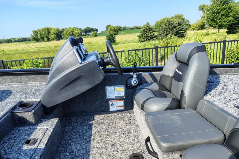 Slide: The Image of 2026 Tracker Pro Team 190 boat interior with steering console and seating. - 4