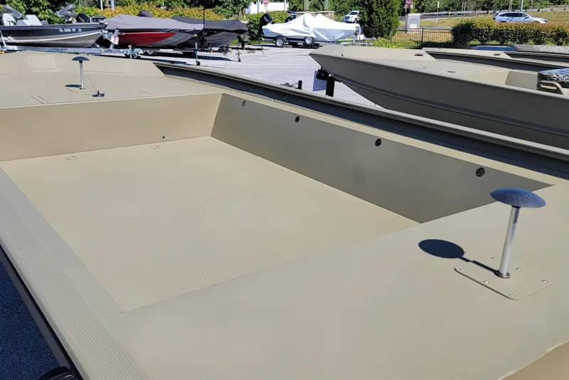 Slide: The Image of 2026 Tracker GRIZZLY 1860 Utility boat, spacious deck, parked outdoors. - 2