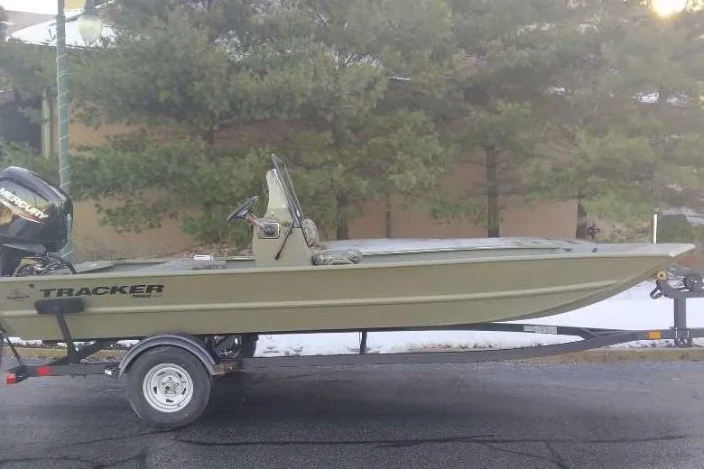 The Image of 2026 Tracker Grizzly 1860 CC boat on trailer, parked outdoors. - 0