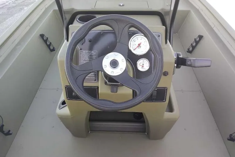 Slide: The Image of Steering console of 2026 Tracker Grizzly 1860 CC boat with gauges and controls. - 2