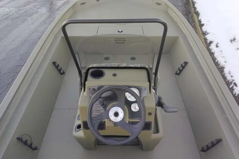 Slide: The Image of 2026 Tracker Grizzly 1860 CC boat interior with steering console and controls. - 4