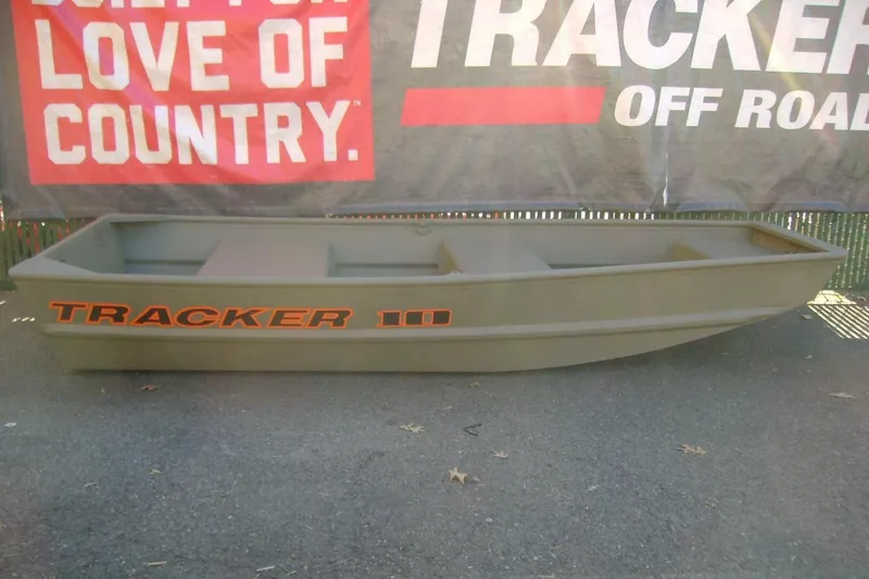 The Image of 2026 Tracker Grizzly 10 Jon boat displayed outdoors with promotional banner. - 0