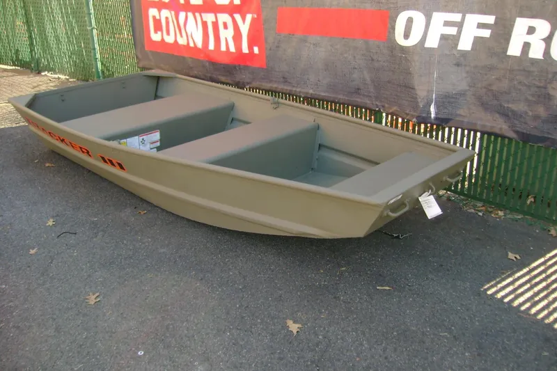 Slide: The Image of 2026 Tracker Grizzly 10 Jon boat displayed outdoors on pavement. - 2